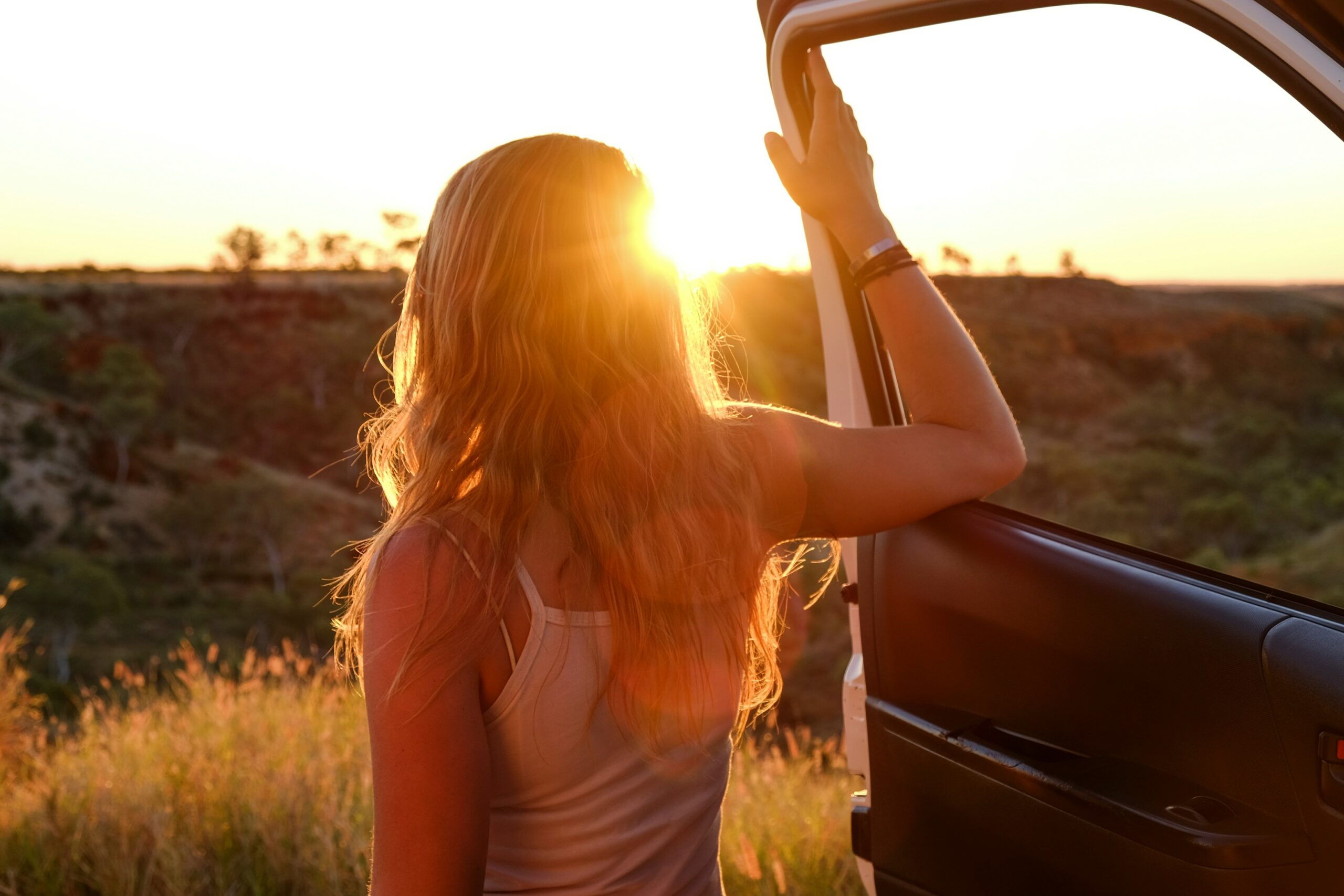 person looking out into nature, girl, arm, freedom